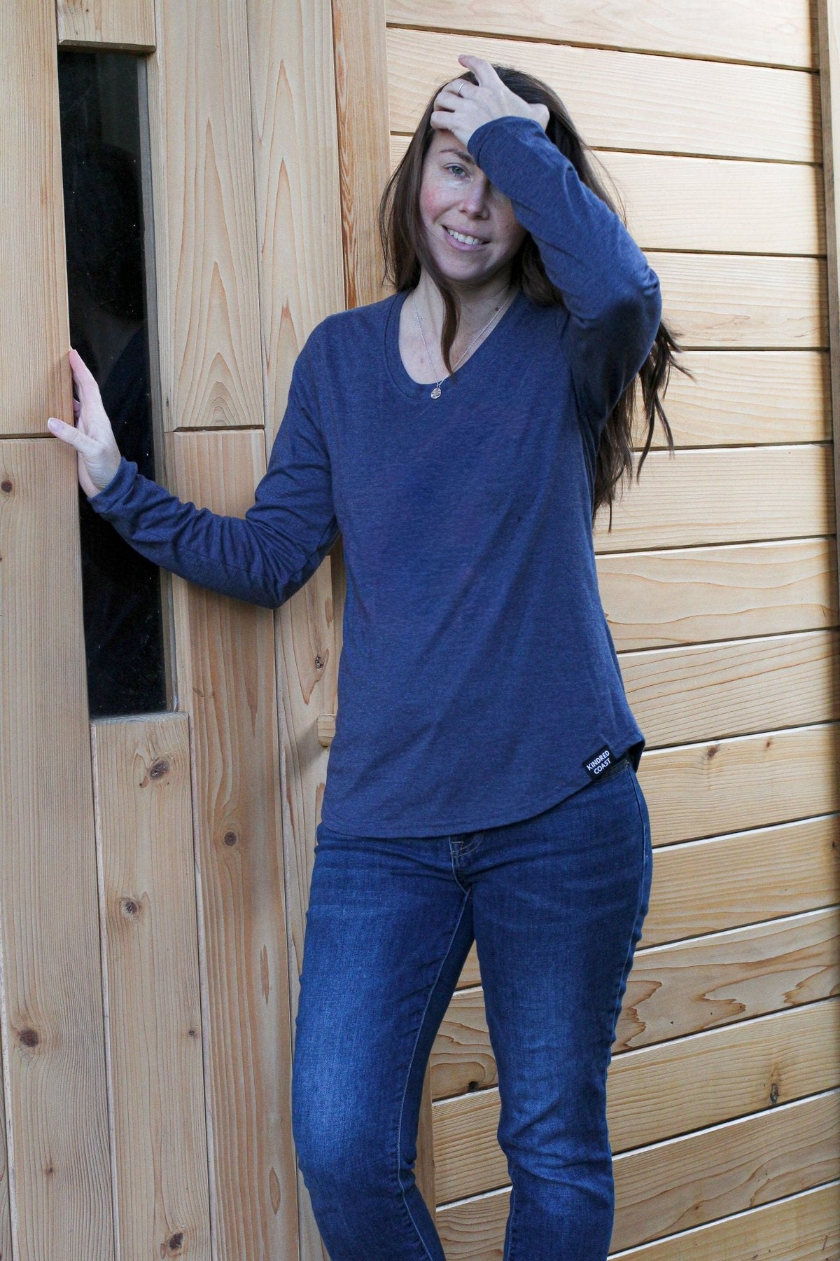 Women’s Heather Navy Eco Long Sleeve Tee by KINDRED COAST, featuring a comfortable fit and eco-friendly fabric from Blank Apparel.