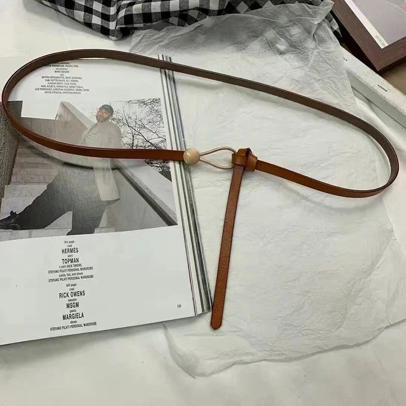 Women's thin bow knotted belt from TrendLux Wear, featuring a stylish bow knot detail and sleek design for versatile fashion.