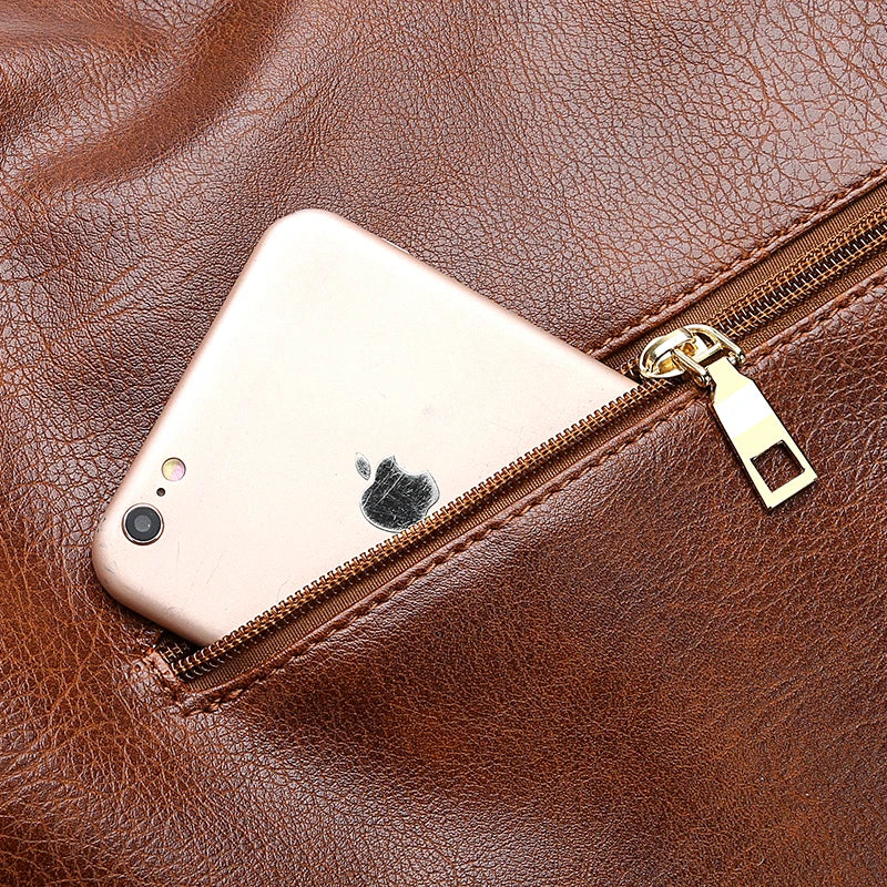 Brown faux leather handbag with a zipper pocket, showing a smartphone partially tucked inside.