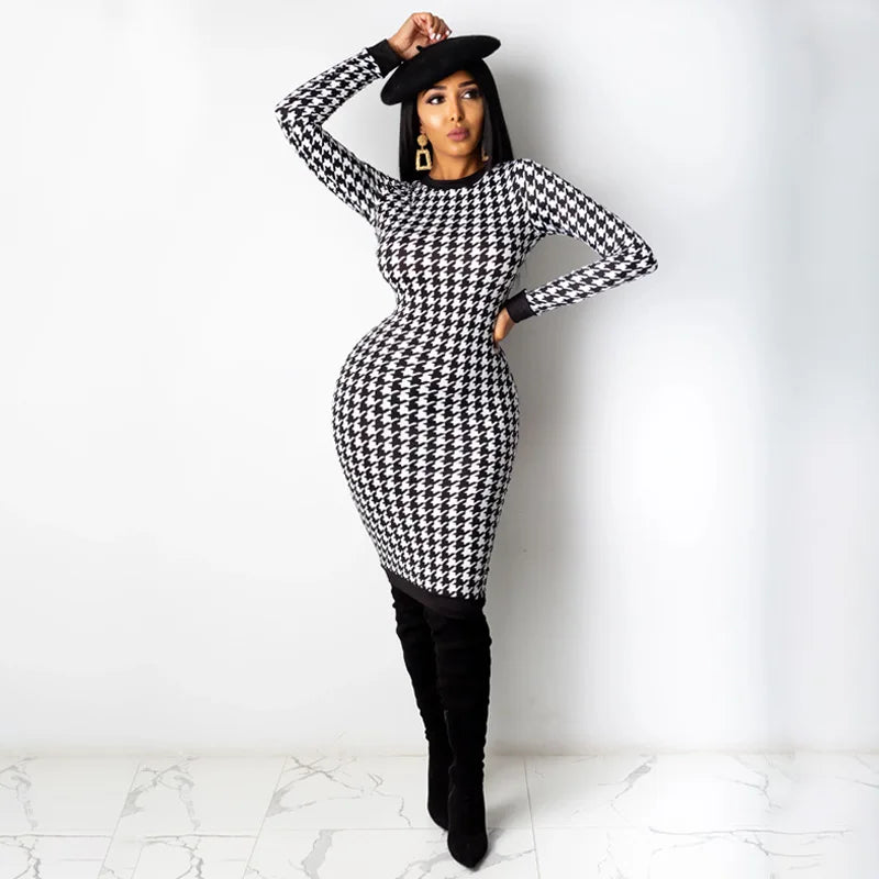 Black and white houndstooth print long sleeve midi dress, slim fit, styled with tall black boots and a hat.