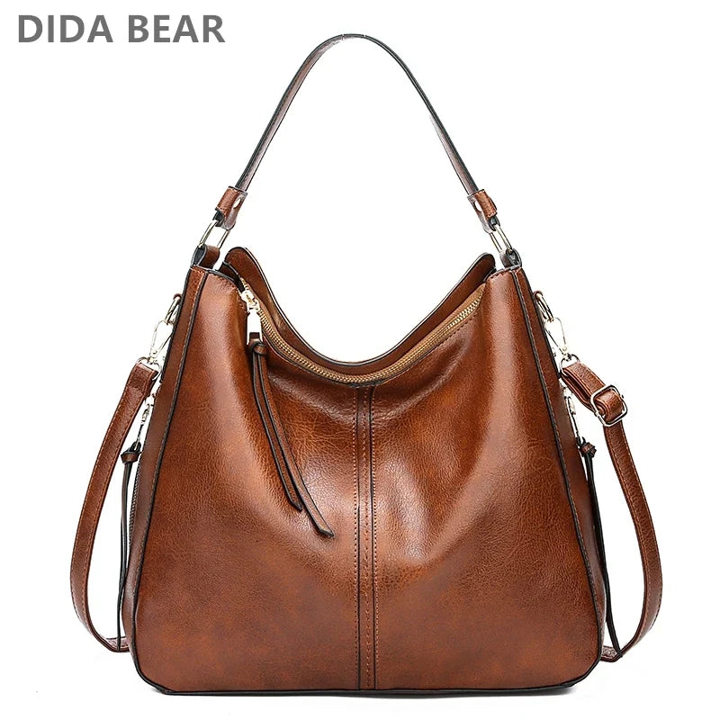Brown faux leather hobo bag with a single shoulder strap and zipper closure, featuring a sleek, casual design.