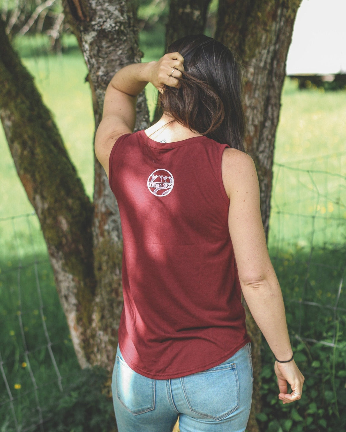 Women’s relaxed bamboo tank top by KINDRED COAST, showing soft fabric and casual fit in a natural stance.