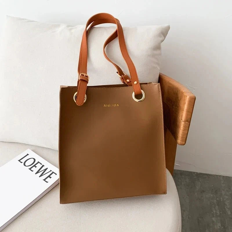 Large women's leather handbag by TrendLux Wear featuring sleek design and high-quality pure leather material.