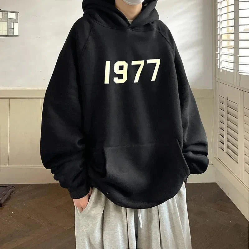Men's TrendLux Wear 1977 Printed Harajuku hoodie with loose fit, long sleeves, and vibrant graphic design on soft sweatshirt fabric.