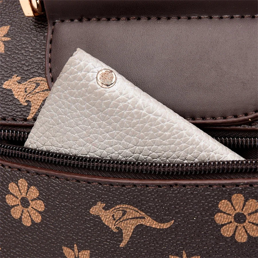 Brown handbag featuring animal prints and floral designs, with a small silver pocket inside. Zipper closure detail visible.