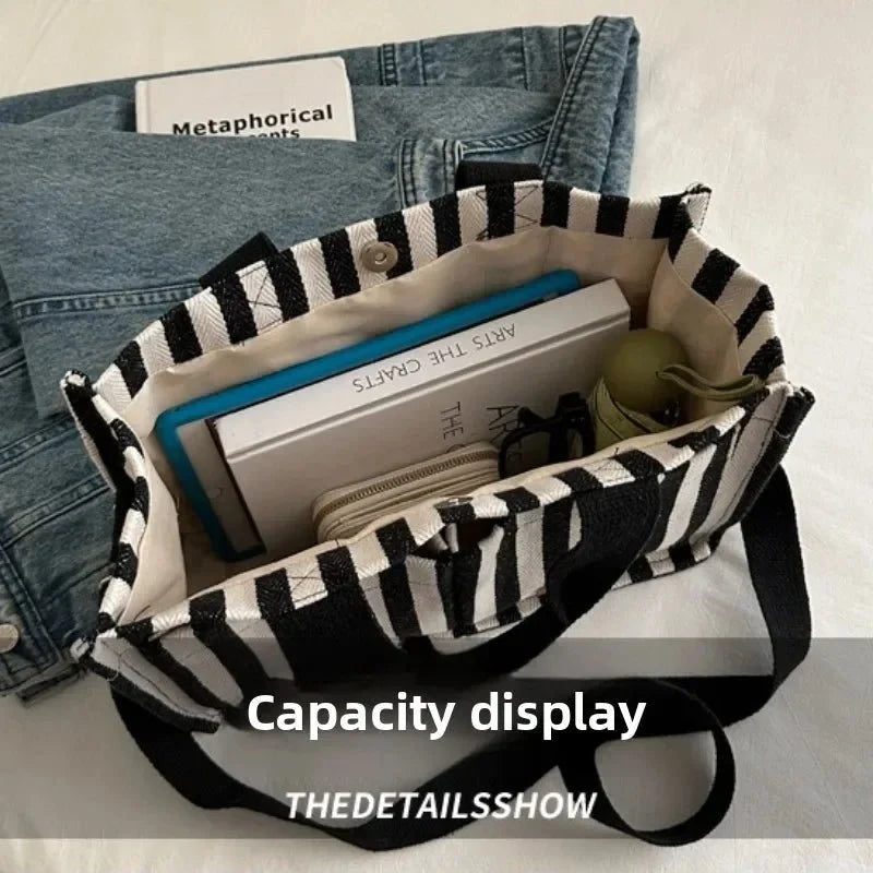 Women's large capacity striped shoulder handbag by TrendLux Wear, featuring a stylish design with multiple compartments.