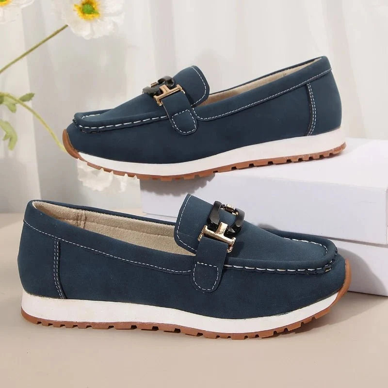 Women's slip-on flat shoes with buckle detail by TrendLux Wear, featuring a sleek design and comfortable fit.