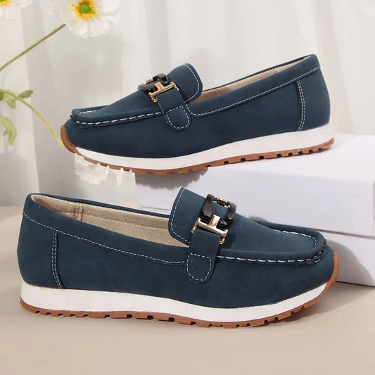 Women's slip-on flat shoes with buckle detail by TrendLux Wear, featuring a sleek design and comfortable fit.