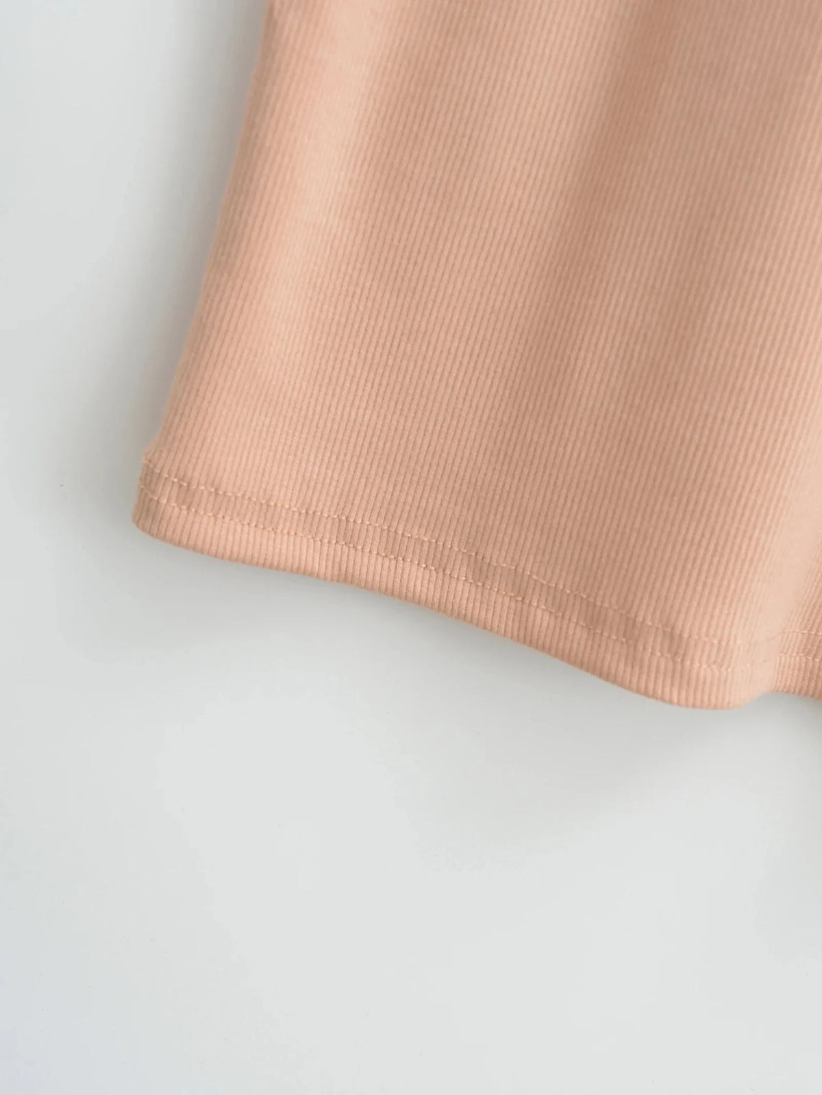 Women's knit turtleneck bodycon ankle-length maxi dress by The Glow Sanctuary, shown in a close-up of the fitted, ribbed fabric.