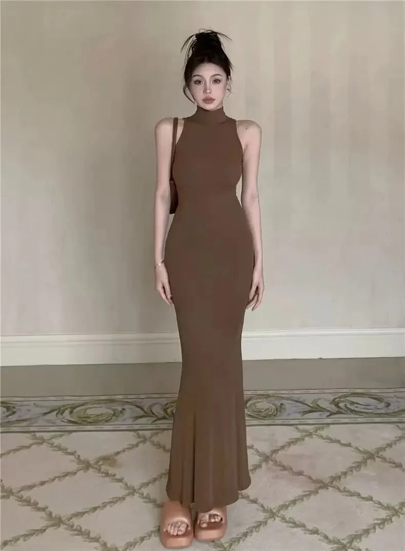 Women's knit turtleneck bodycon ankle-length maxi dress by The Glow Sanctuary, featuring a fitted design and cozy knit fabric.