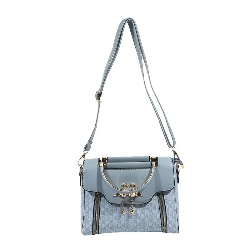 Versatile grey handbag with embossed pattern, gold embellishments, and adjustable shoulder strap. Perfect for casual wear.