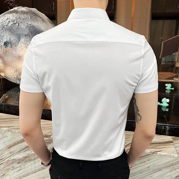 Short sleeve white shirt with a square collar, designed for men. Features a sleek, clean back view.