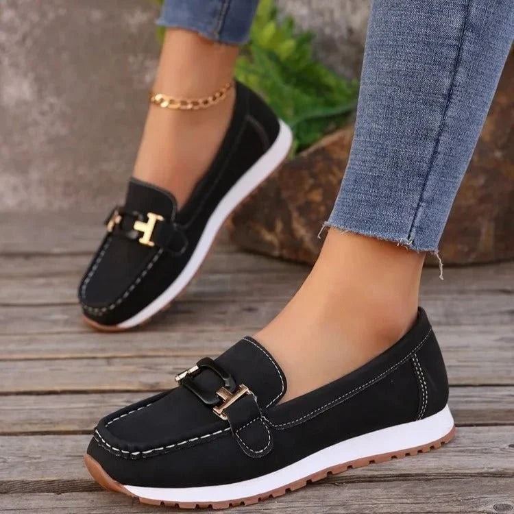 Women's slip-on flat shoes with buckle detail by TrendLux Wear, featuring a sleek design and comfortable fit.