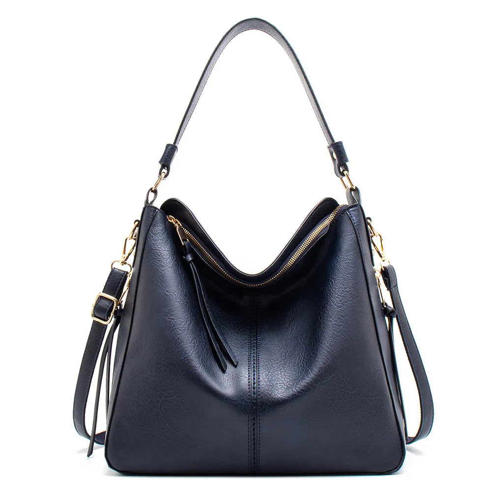 Large black faux leather hobo bag with a gold zipper and a single shoulder strap, showcasing a casual style.