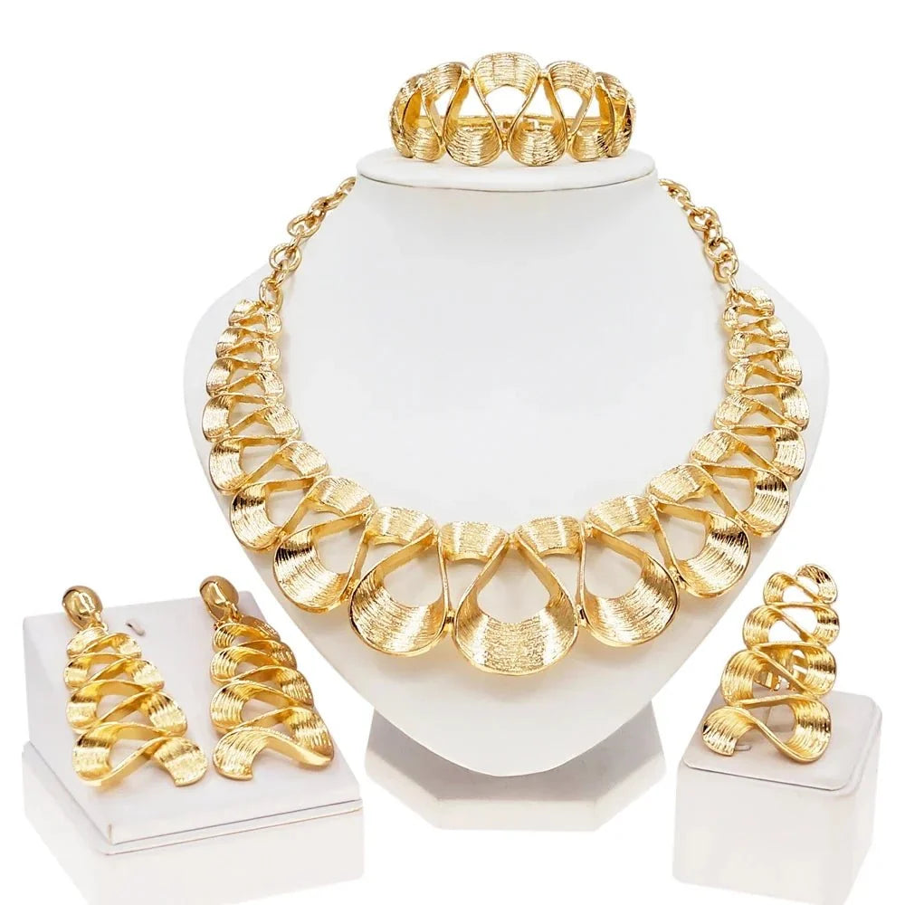 Gold plated women's jewelry set with wavy pendant necklace and matching earrings by TrendLux Wear.