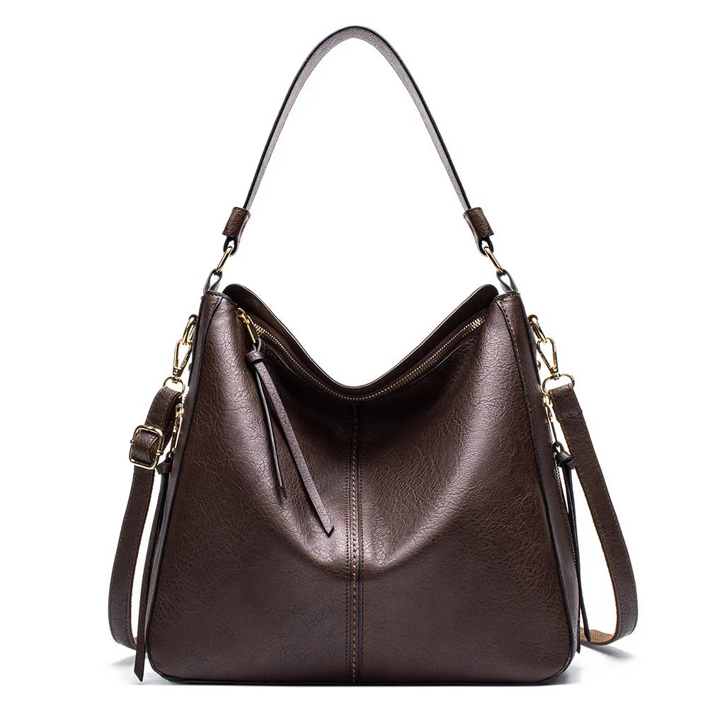 Brown faux leather hobo bag with gold-tone hardware, a single handle, and a detachable shoulder strap.