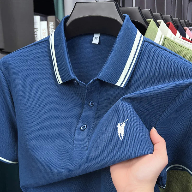 Navy blue short sleeve polo shirt featuring white striped collar and classic pony embroidery. Made from 100% cotton.