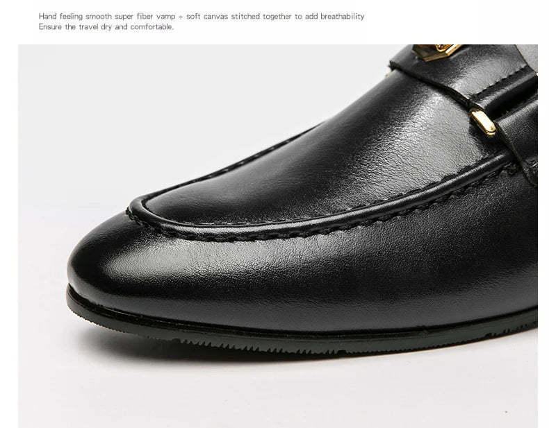 Elegant black leather slip-on loafers with a round toe and a gold metal buckle detail.