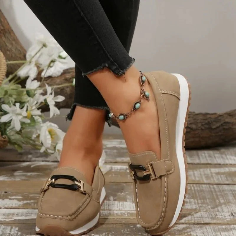 Women's slip-on flat shoes with buckles by TrendLux Wear, featuring a sleek design and comfortable fit.