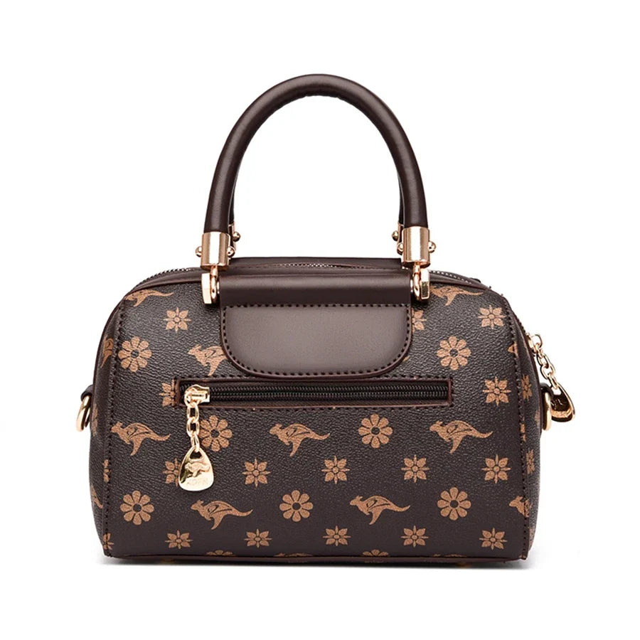 Designer shoulder bag in dark brown PU leather featuring animal print and floral patterns, with gold accents and zipper closure.