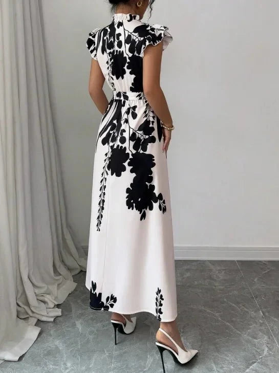 Women's black and white patchwork sash ball gown dress by The Glow Sanctuary, featuring a flowing polyester fabric and elegant design.