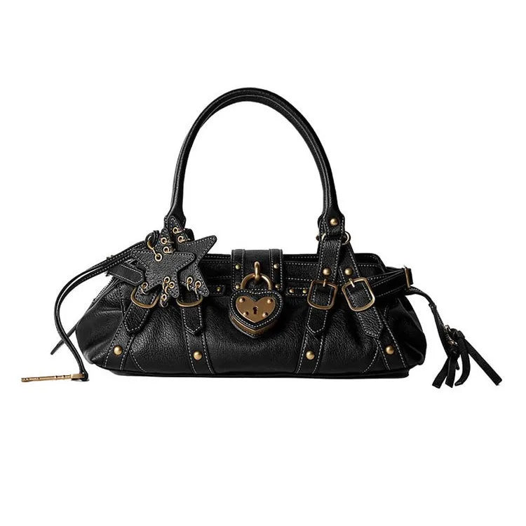 Black handbag with rivet embellishments, star applique, and heart-shaped detail; features single handle and crossbody strap.