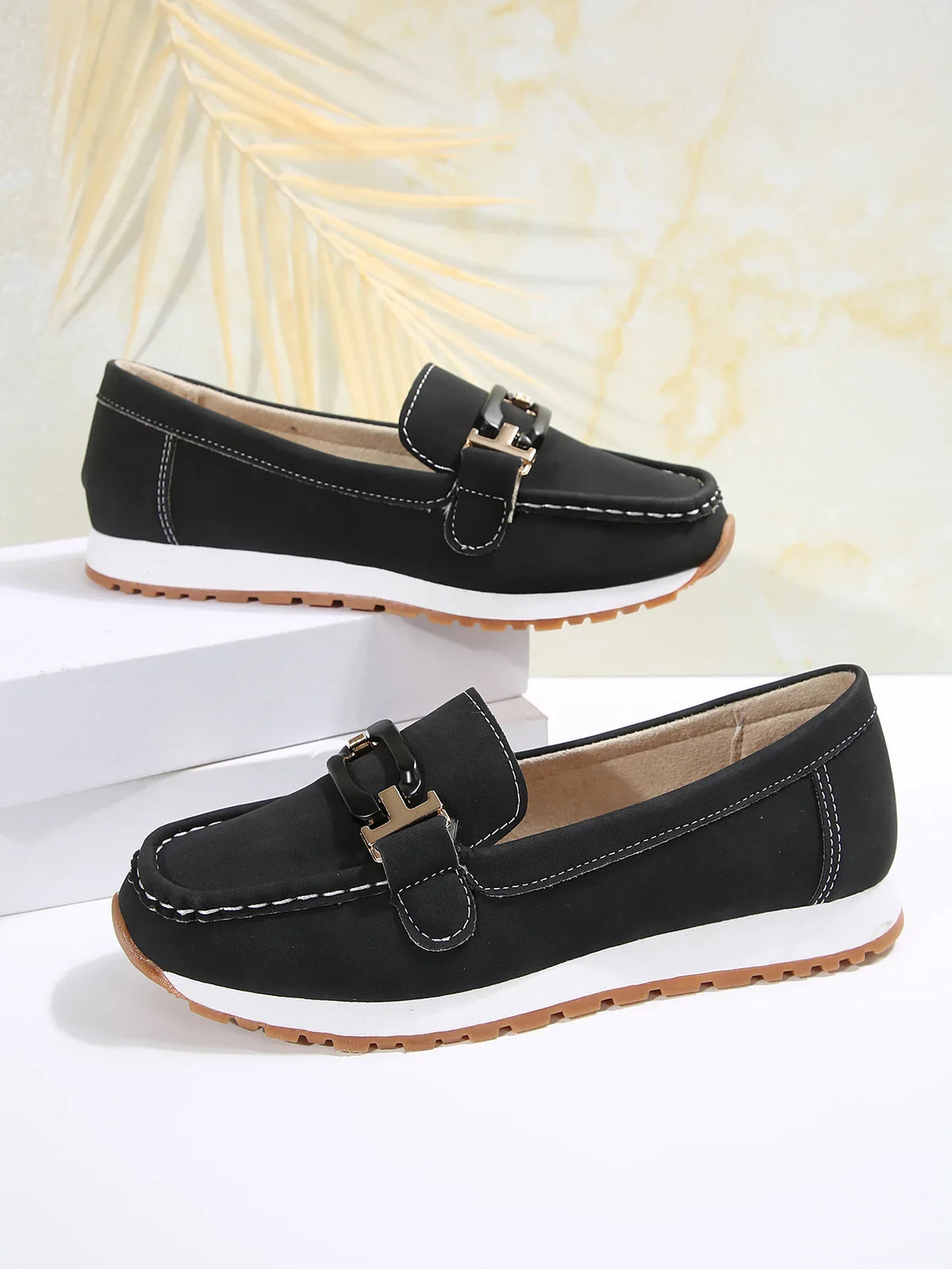 Women's slip-on flat shoes with buckle detail from TrendLux Wear, showcasing a stylish and comfortable footwear option.