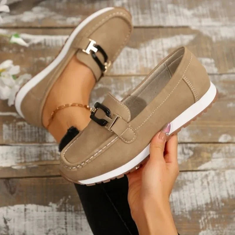 Women's slip-on shoes with buckle detail from TrendLux Wear, featuring a flat design and comfortable fit.