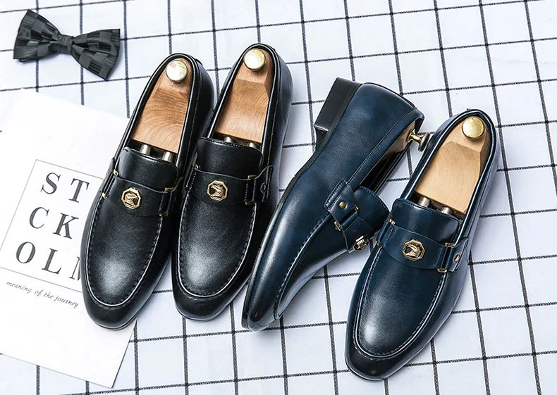 Elegant slip-on loafers featuring a shiny black upper with a decorative metal buckle, perfect for formal occasions.
