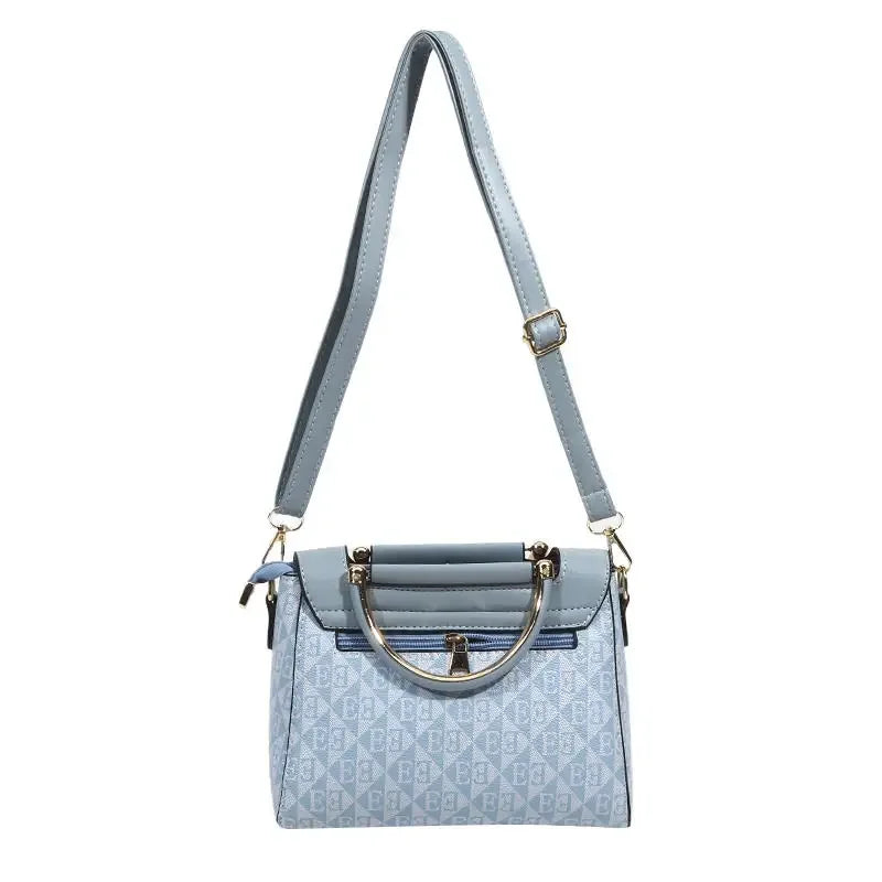 Light blue embossed handbag with a structured rectangular shape, soft synthetic leather, and a stylish metal handle.