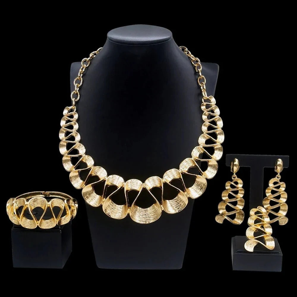 Women's gold plated wavy pendant necklace and matching earrings jewelry set by TrendLux Wear, with elegant flowing design.