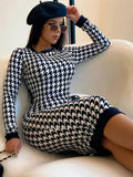 Houndstooth print long sleeve midi dress in black and white, slim fit, worn with a black beret and sunglasses.