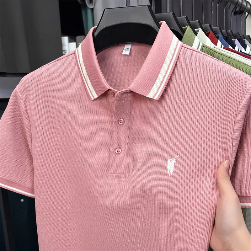 Light pink short sleeve polo shirt with a classic collar, white embroidery logo, and striped detailing on the collar.