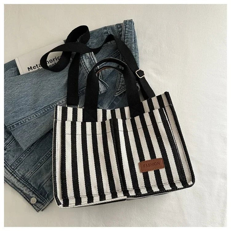 Women's large capacity striped shoulder handbag by TrendLux Wear, stylish accessory with multiple compartments and shoulder strap.