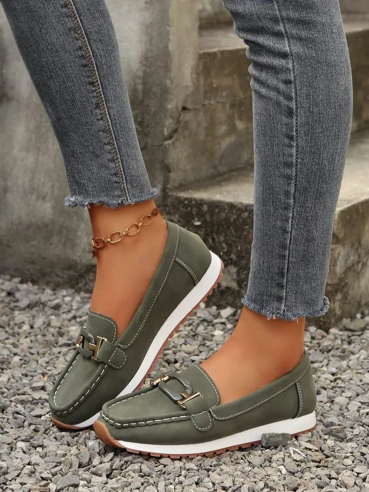 Women's TrendLux Wear buckle flat slip-on shoes with a sleek design, perfect for casual and comfortable everyday wear.