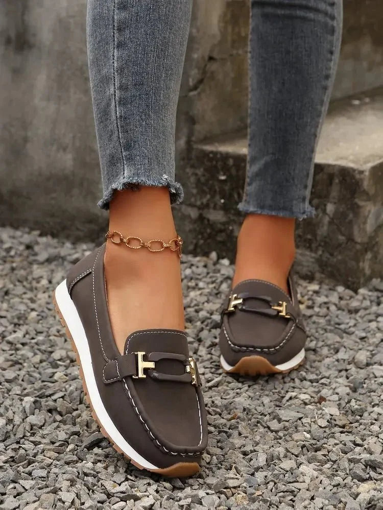 Women's slip-on flat shoes with buckle detail by TrendLux Wear, showcasing a sleek, comfortable design perfect for casual wear.