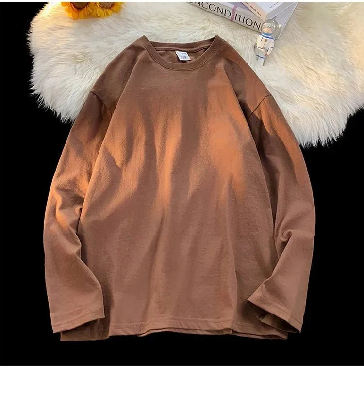 Unisex oversized long sleeve blank T-shirt in neutral color, casual streetwear style, available in multiple sizes and colors.