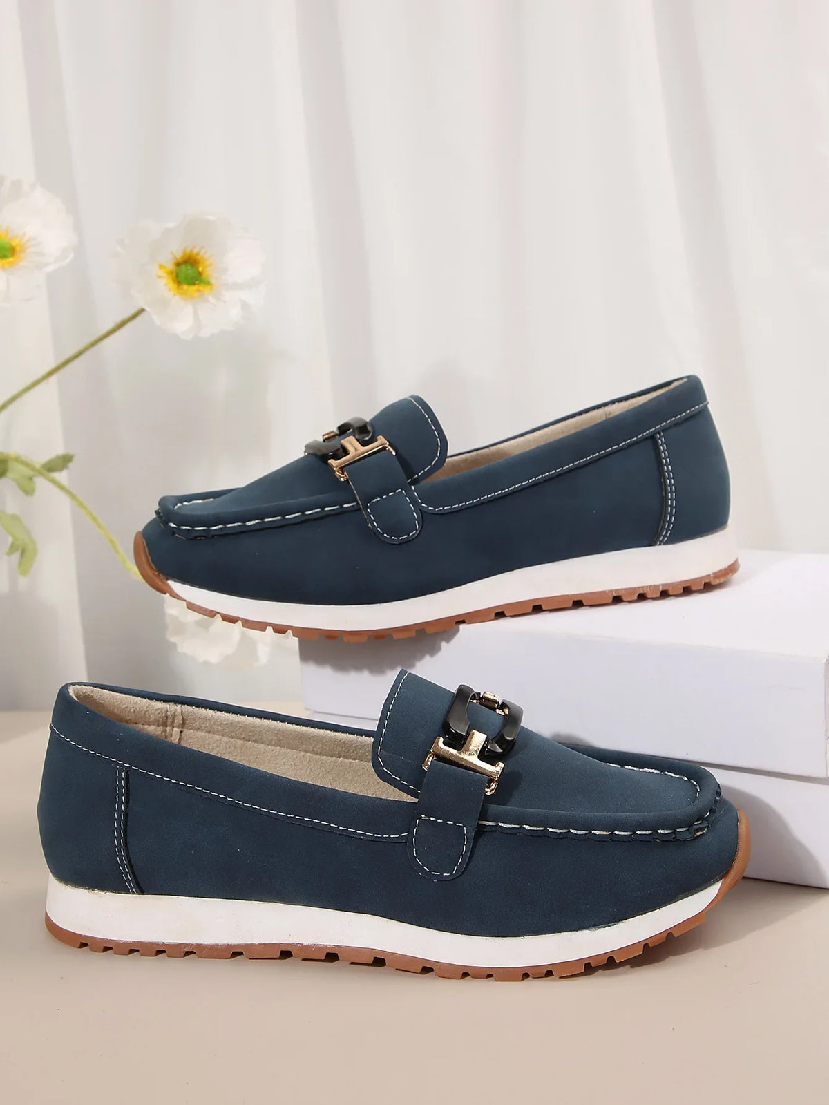 Women's slip-on flat shoes with buckle detail from TrendLux Wear, featuring a sleek, comfortable design perfect for everyday wear.