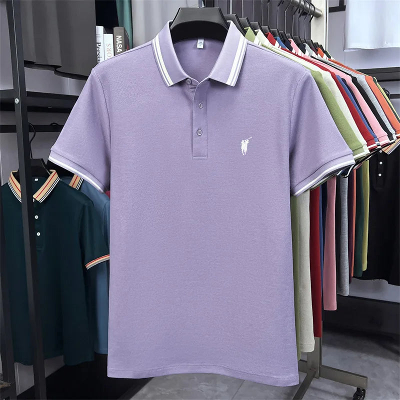Lavender short sleeve polo shirt with a white embroidered pony logo and striped collar, displayed against a rack of colorful shirts.