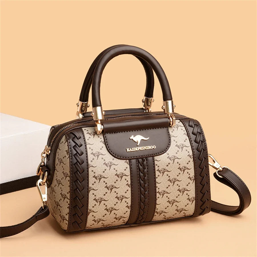 Brown and beige designer shoulder bag with a woven style and gold-tone accents, featuring dual handles and a removable strap.