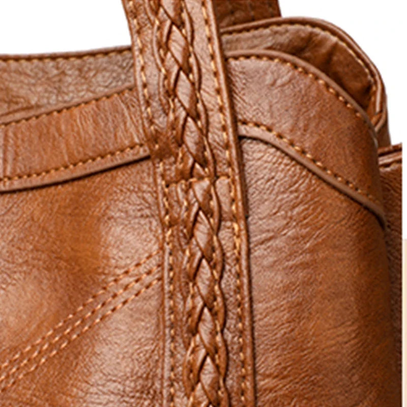 Brown leather crossbody bag with braided strap and stitching details. Casual tote style, suitable for various occasions.