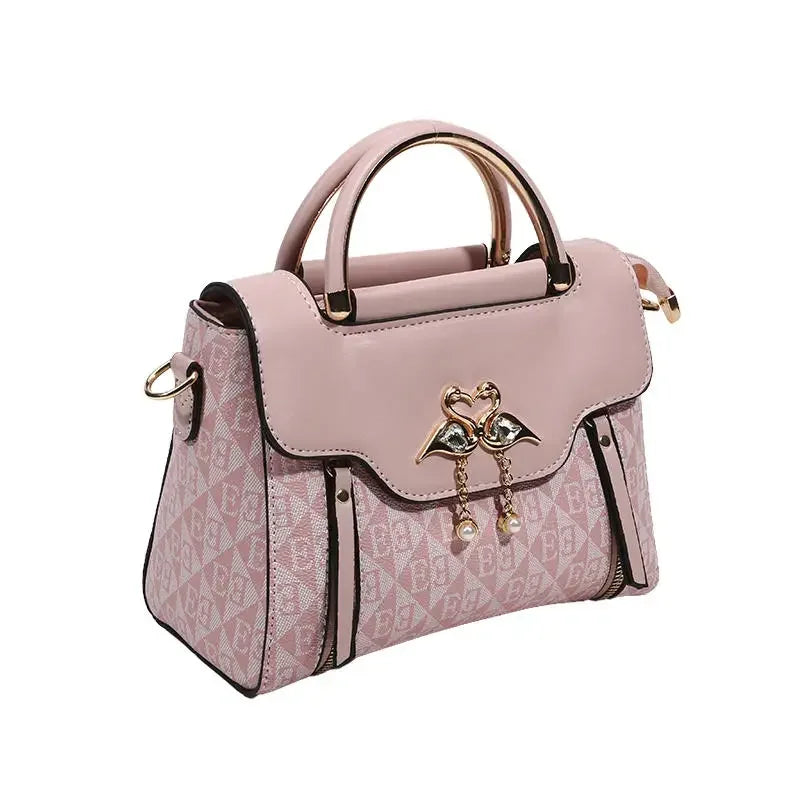 Versatile casual shoulder handbag in light pink with embossed pattern, gold accents, and dual handles.