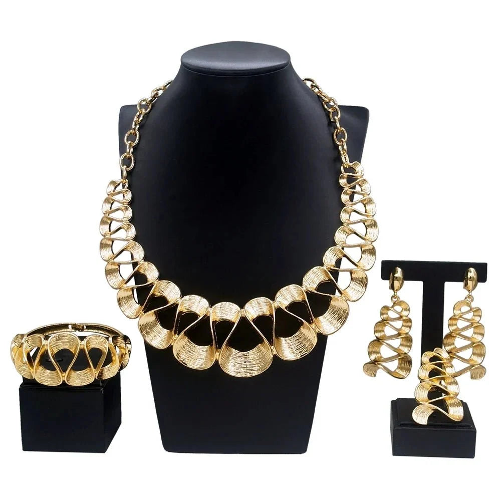 Gold plated women's wavy jewelry set with pendant necklace and matching earrings from TrendLux Wear.