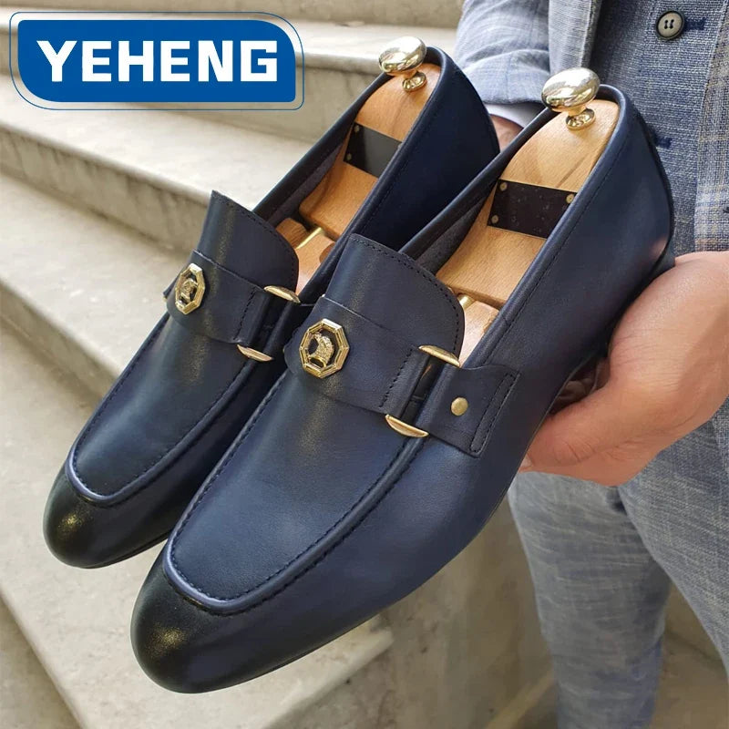 Men's slip-on dress loafers in dark blue leather with a round toe, featuring a gold metal buckle detail.