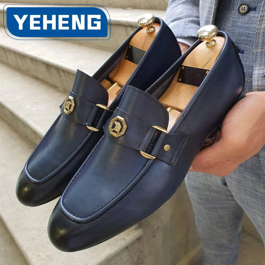Men's slip-on dress loafers in dark blue leather with a round toe, featuring a gold metal buckle detail.