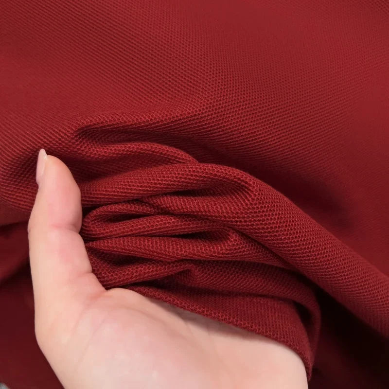 Burgundy short sleeve polo shirt crafted from breathable cotton, showcasing a textured design and comfortable fit.