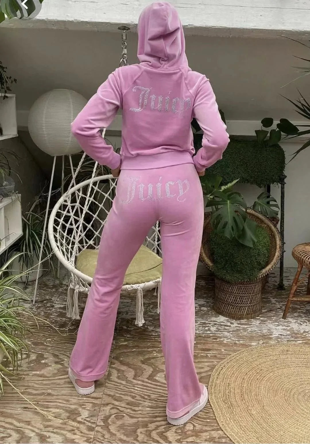 Women's Y2K style two-piece hooded tracksuit by TrendLux Wear, featuring long-sleeve jacket and flare jogger pants in black.