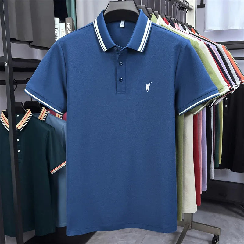 Short sleeve polo shirt in solid navy blue with white striped collar and small pony embroidery, displayed on a hanger.