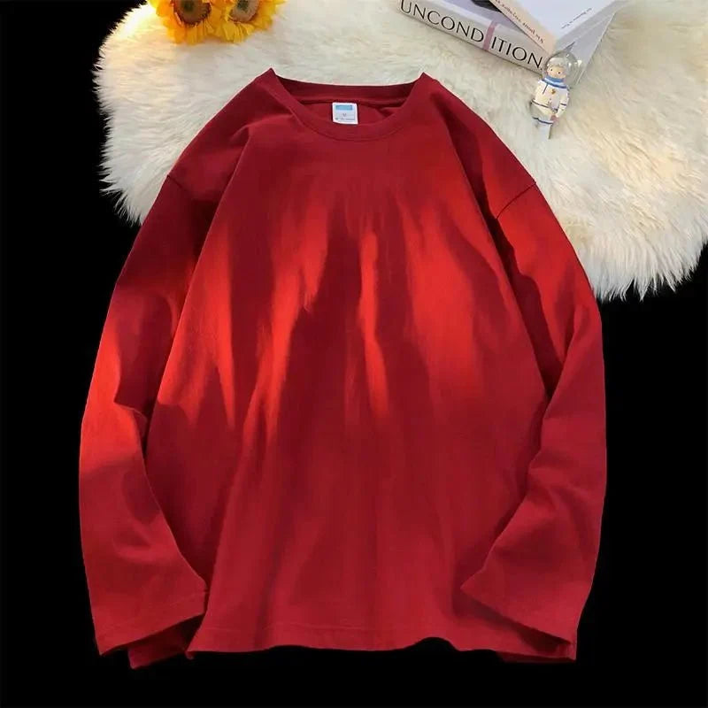 Unisex oversized long sleeve blank T-shirt by My Store 5 in various colors, shown in a relaxed fit on a model.