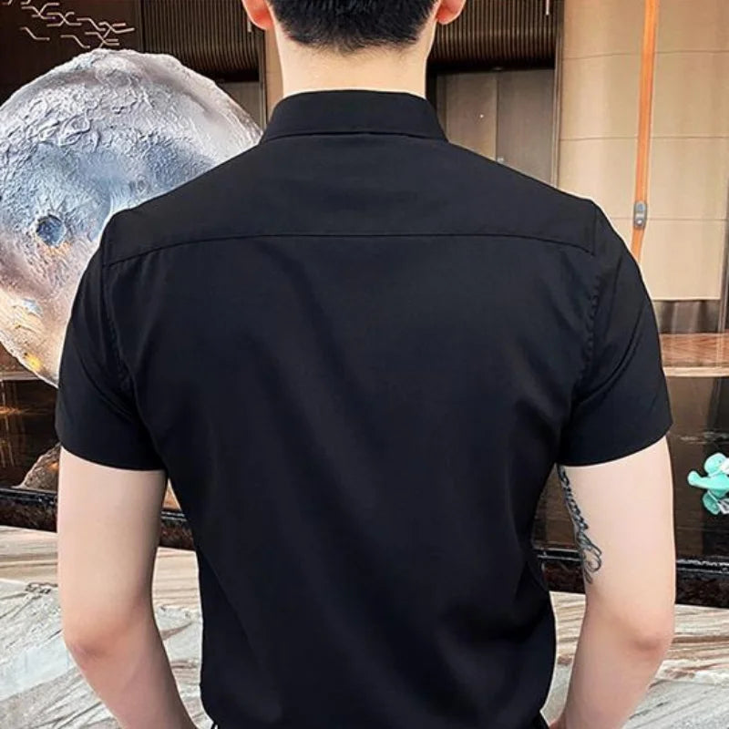Short-sleeve black shirt with a square collar, worn by a model from the back, featuring a plain design and regular fit.